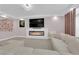Cozy living room with modern fireplace, wall-mounted television, and stylish decor at 5788 Robin Ridge Ave, Las Vegas, NV 89141
