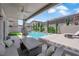 Charming covered patio overlooking the pool area with comfortable seating and a ceiling fan at 5788 Robin Ridge Ave, Las Vegas, NV 89141