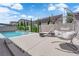 Backyard pool features privacy landscaping and patio seating under a sunny blue sky at 5788 Robin Ridge Ave, Las Vegas, NV 89141