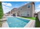 Backyard pool features privacy landscaping, artificial grass, and a covered patio at 5788 Robin Ridge Ave, Las Vegas, NV 89141