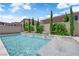 Backyard pool features water features, privacy landscaping, and a sunny blue sky at 5788 Robin Ridge Ave, Las Vegas, NV 89141