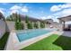 Backyard pool features water features, privacy landscaping, and outdoor seating under a blue sky at 5788 Robin Ridge Ave, Las Vegas, NV 89141