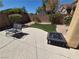 Landscaped backyard featuring desert landscaping, artificial grass, and privacy walls at 6009 Arbor Crest St, North Las Vegas, NV 89081