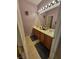Bathroom featuring tile flooring, double vanity and large mirror at 6009 Arbor Crest St, North Las Vegas, NV 89081