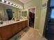 Bathroom featuring tile flooring, double vanity and a walk-in closet at 6009 Arbor Crest St, North Las Vegas, NV 89081