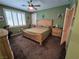 Bedroom featuring carpet, a ceiling fan, and plantation shutters, offering a cozy and inviting space at 6009 Arbor Crest St, North Las Vegas, NV 89081