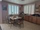 Bright dining area with shuttered windows providing natural light, surrounded by ample counter space at 6009 Arbor Crest St, North Las Vegas, NV 89081