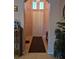 Inviting foyer with a tile floor and natural light coming through clerestory windows above the front door at 6009 Arbor Crest St, North Las Vegas, NV 89081