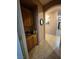 Hallway featuring tile floors, decorative mirror, and built-in cabinets at 6009 Arbor Crest St, North Las Vegas, NV 89081