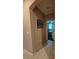 Neutral hallway leading to a bedroom, featuring tile flooring and fresh paint at 6009 Arbor Crest St, North Las Vegas, NV 89081