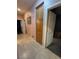 Hallway with tile floors, built in storage, and neutral paint tones throughout at 6009 Arbor Crest St, North Las Vegas, NV 89081