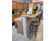 Kitchen with a breakfast bar island featuring a granite countertop and barstool seating at 6009 Arbor Crest St, North Las Vegas, NV 89081
