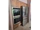 Modern kitchen appliances including built-in ovens and a stainless steel refrigerator at 6009 Arbor Crest St, North Las Vegas, NV 89081