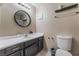 Bathroom featuring an updated vanity with a white countertop, a round mirror, and a standard toilet at 6224 Mandarin Dr, Las Vegas, NV 89108