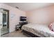 Bedroom featuring tile flooring, neutral paint colors, a television, and a small window at 6224 Mandarin Dr, Las Vegas, NV 89108