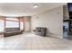 Living room featuring tile flooring, neutral paint colors, and a large window allowing lots of natural light at 6224 Mandarin Dr, Las Vegas, NV 89108