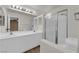 Bright bathroom featuring double sinks, white cabinets, and a modern glass-enclosed shower at 638 Ribbon Grass Ave, Las Vegas, NV 89183
