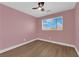 Bedroom featuring a ceiling fan, window, and wood-look flooring at 638 Ribbon Grass Ave, Las Vegas, NV 89183