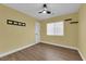 Bedroom featuring a ceiling fan, window, and wood-look flooring at 638 Ribbon Grass Ave, Las Vegas, NV 89183