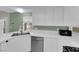 White kitchen featuring stainless steel appliances and tile countertops at 638 Ribbon Grass Ave, Las Vegas, NV 89183