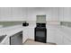 Kitchen area featuring stainless steel appliances, tiled counters, and sleek black range at 638 Ribbon Grass Ave, Las Vegas, NV 89183