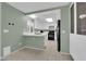 Eat-in kitchen area with tiled floors, white cabinetry, and stainless steel appliances at 638 Ribbon Grass Ave, Las Vegas, NV 89183