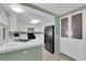 Bright kitchen featuring tiled countertops and backsplash with black appliances and ample cabinetry at 638 Ribbon Grass Ave, Las Vegas, NV 89183