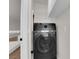 Modern laundry room with black washing machine and white shelving at 638 Ribbon Grass Ave, Las Vegas, NV 89183