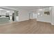 Open-concept living area with wood-look floors, kitchen, and staircase views at 638 Ribbon Grass Ave, Las Vegas, NV 89183