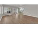 Open-concept space featuring wood-look floors with sliding glass doors and modern kitchen at 638 Ribbon Grass Ave, Las Vegas, NV 89183