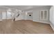 Spacious living room with wood-look floors, staircase, and views to kitchen and entry at 638 Ribbon Grass Ave, Las Vegas, NV 89183