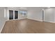 Modern living room with wood-look flooring, windows, and double doors to the exterior at 638 Ribbon Grass Ave, Las Vegas, NV 89183
