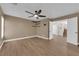 Neutral main bedroom with wood-look floors, ceiling fan, and easy access to other rooms at 638 Ribbon Grass Ave, Las Vegas, NV 89183
