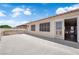 View of the concrete patio, windows and door to the home at 638 Ribbon Grass Ave, Las Vegas, NV 89183