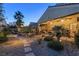 The spacious backyard shows a covered patio, lounge chairs, and desert landscaping at 6413 White Tiger Ct, Las Vegas, NV 89130