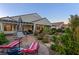Landscaped backyard featuring a patio, lush greenery, and outdoor seating, perfect for relaxing and entertaining at 6413 White Tiger Ct, Las Vegas, NV 89130