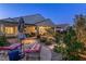 This backyard shows a covered patio area with comfortable seating and desert landscaping at 6413 White Tiger Ct, Las Vegas, NV 89130