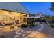 This backyard has a covered patio area, desert landscaping, and a stone pathway at 6413 White Tiger Ct, Las Vegas, NV 89130