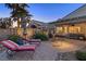 A backyard patio includes comfortable seating and desert landscaping at 6413 White Tiger Ct, Las Vegas, NV 89130