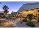 The backyard features a covered patio, desert landscaping, and a stone pathway at 6413 White Tiger Ct, Las Vegas, NV 89130