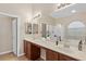 Bright bathroom featuring double sinks, granite countertops, and a separate tub and shower at 6413 White Tiger Ct, Las Vegas, NV 89130