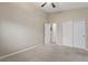 Bright bedroom featuring a ceiling fan, a closet, neutral walls, and carpeted floor at 6413 White Tiger Ct, Las Vegas, NV 89130