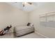 Cozy bedroom with natural light, showcasing a striped bed, and a golf bag, perfect for relaxation at 6413 White Tiger Ct, Las Vegas, NV 89130
