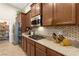 Well-equipped kitchen showcases ample counter space, modern appliances, and custom backsplash details at 6413 White Tiger Ct, Las Vegas, NV 89130