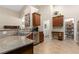 Spacious kitchen featuring granite countertops, stainless steel appliances, and a view of the laundry room at 6413 White Tiger Ct, Las Vegas, NV 89130