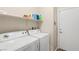 Efficient laundry room featuring a modern washer and dryer, and storage shelf for organization at 6413 White Tiger Ct, Las Vegas, NV 89130