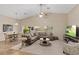 Open-concept living room features a ceiling fan, plush sofa, and plenty of natural light at 6413 White Tiger Ct, Las Vegas, NV 89130