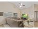 Inviting living room featuring tile floors, neutral paint, and a comfortable sofa at 6413 White Tiger Ct, Las Vegas, NV 89130