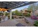 Relaxing outdoor patio with pergola, complete with comfortable seating and lush landscaping, creating a private retreat at 6413 White Tiger Ct, Las Vegas, NV 89130