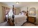 Charming bedroom featuring a four-poster bed, ornate furniture, and a soft color palette at 6705 Philharmonic Ave, Las Vegas, NV 89139